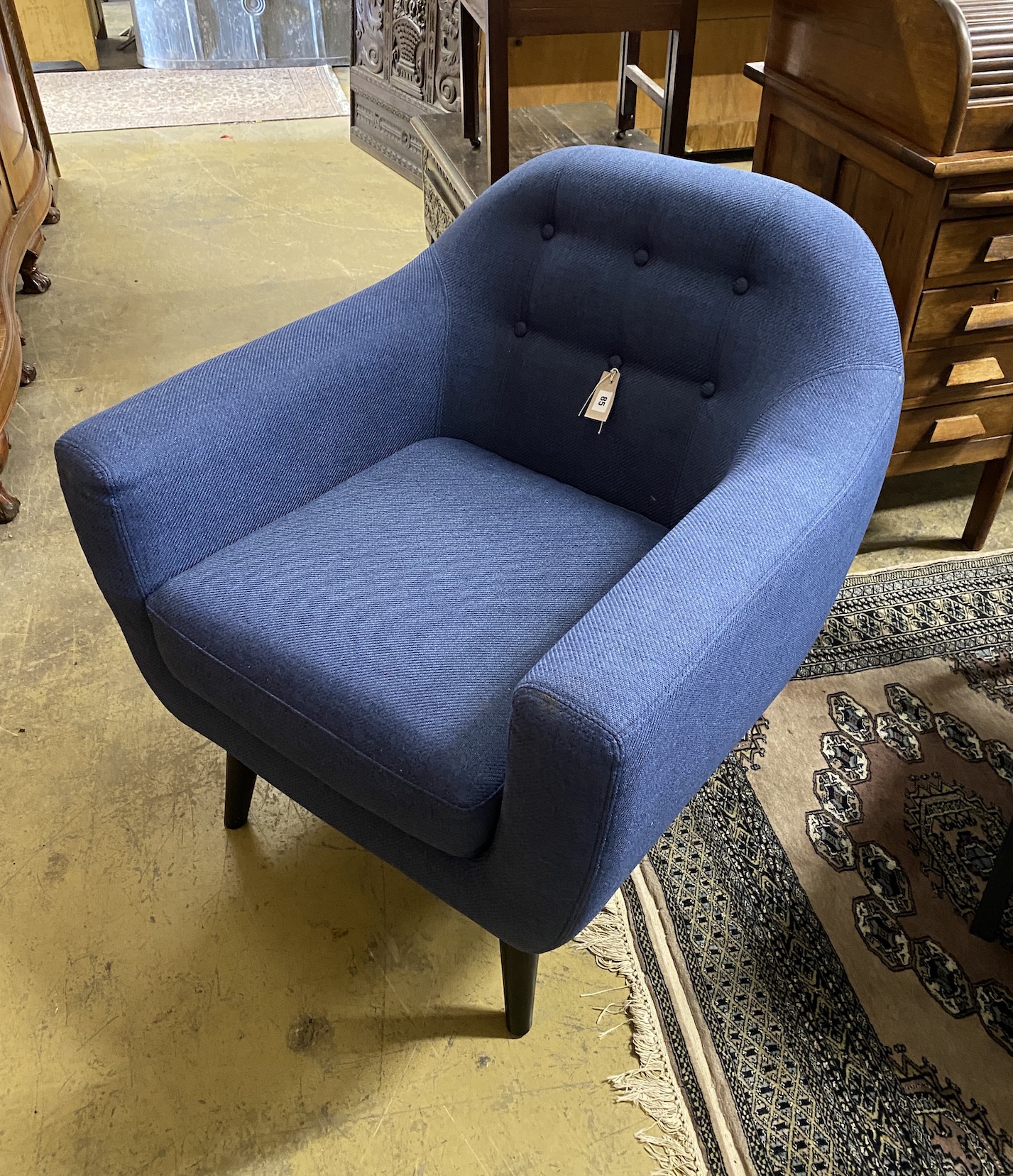 A contemporary blue fabric armchair, width 81cm, depth 74cm, height 84cm